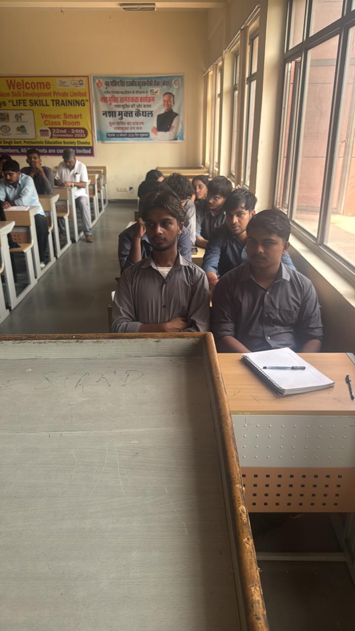 Two students seated beside the classroom windows during a session.
